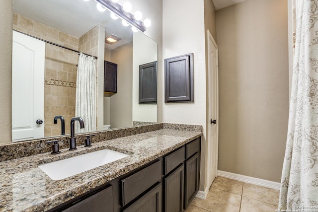 bathroom featuring curtained shower, toilet, vanity, tile patterned flooring, and baseboards