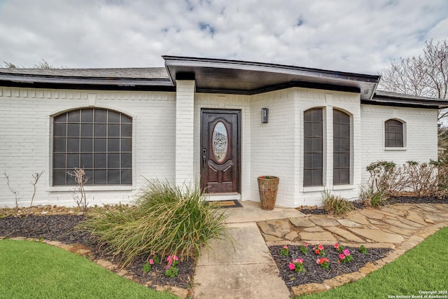 property entrance with brick siding