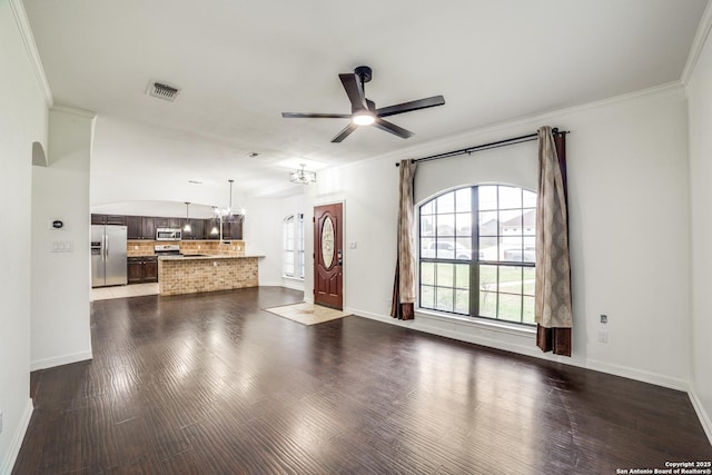 living area with dark wood finished floors, crown molding, visible vents, baseboards, and ceiling fan with notable chandelier