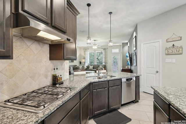 kitchen with appliances with stainless steel finishes, a sink, under cabinet range hood, and dark brown cabinets