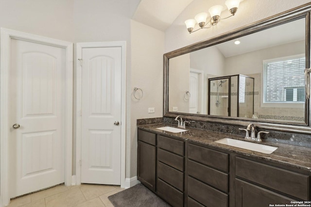 bathroom with double vanity, a stall shower, tile patterned flooring, and a sink