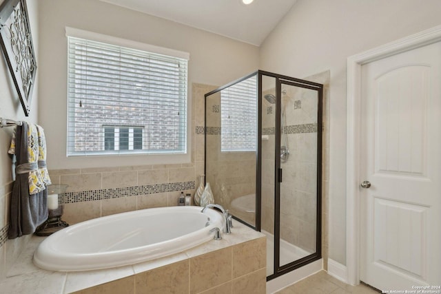 full bath with vaulted ceiling, a stall shower, a garden tub, and tile patterned floors