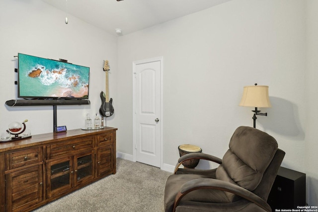 living area with light carpet and baseboards