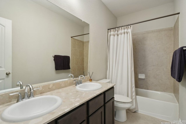 bathroom featuring tile patterned flooring, a sink, toilet, and shower / tub combo with curtain