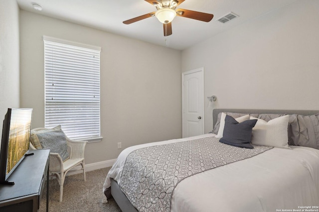 bedroom featuring a ceiling fan, carpet, visible vents, and baseboards