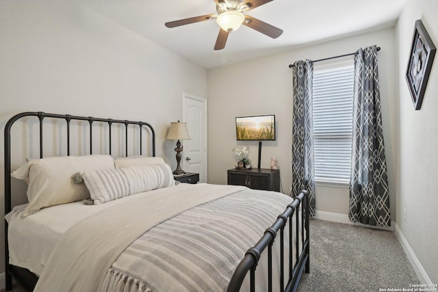 carpeted bedroom with a ceiling fan and baseboards