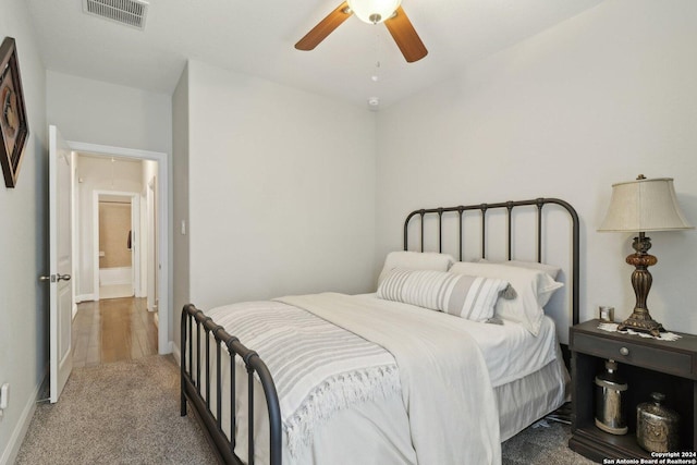 bedroom featuring attic access, visible vents, baseboards, ceiling fan, and carpet floors