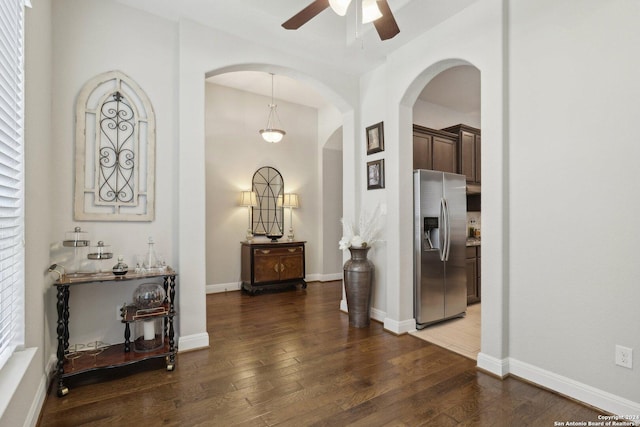 hall featuring hardwood / wood-style flooring and baseboards