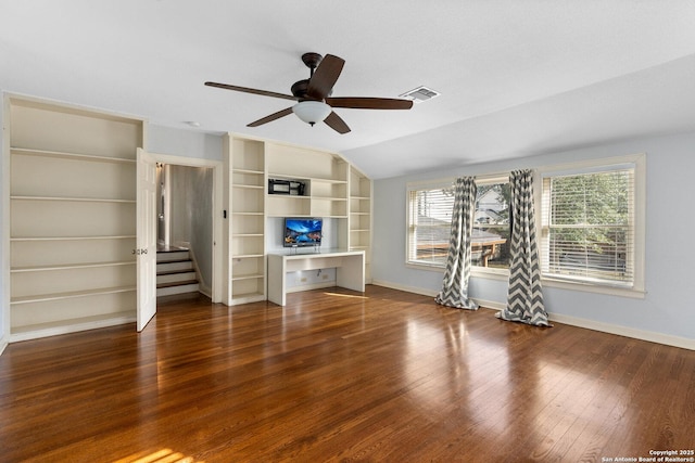 unfurnished living room featuring vaulted ceiling, built in study area, hardwood / wood-style flooring, and baseboards