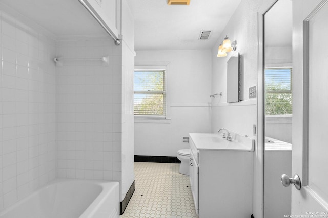 bathroom featuring toilet, visible vents, vanity, baseboards, and  shower combination