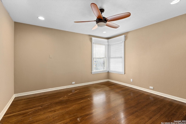 empty room with dark wood-type flooring, recessed lighting, and baseboards