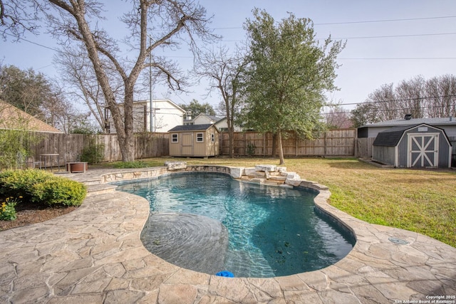 view of swimming pool with an outbuilding, a fenced backyard, and a shed