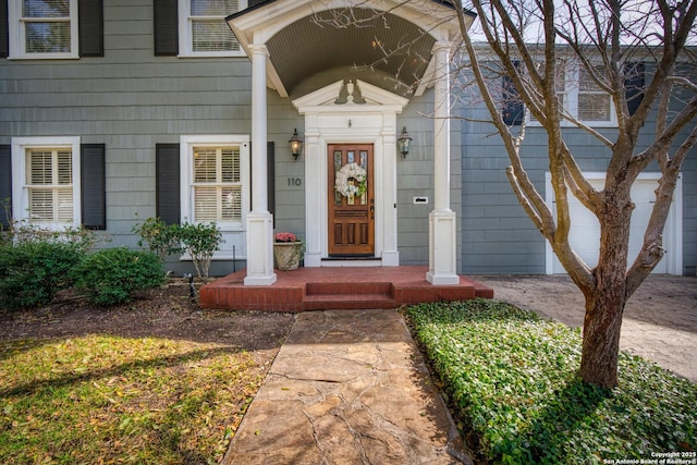 view of exterior entry featuring a garage