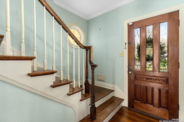 foyer entrance featuring crown molding, dark wood finished floors, and baseboards