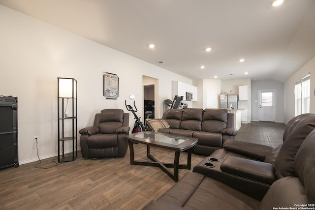 living area featuring vaulted ceiling, visible vents, dark wood finished floors, and recessed lighting