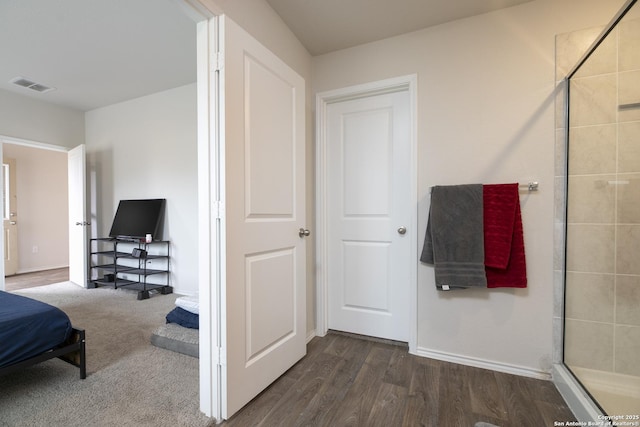 bedroom featuring visible vents, dark wood finished floors, and baseboards