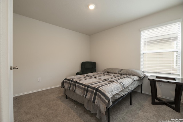 carpeted bedroom featuring baseboards