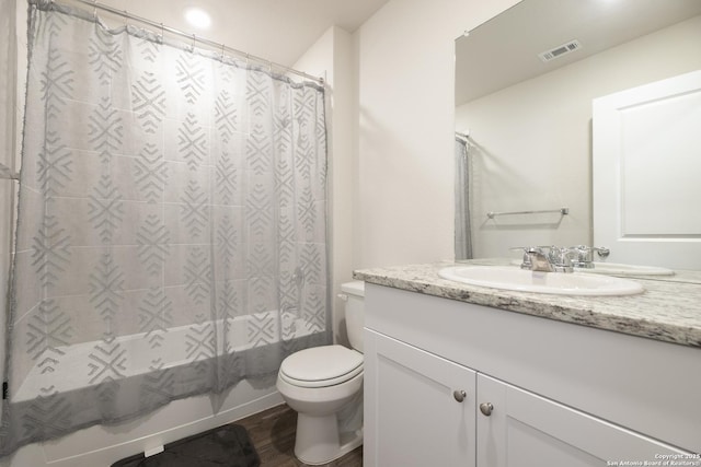 full bath with visible vents, toilet, shower / bath combo, vanity, and wood finished floors