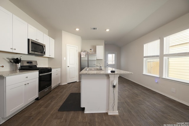 kitchen featuring a center island with sink, visible vents, white cabinets, dark wood finished floors, and stainless steel appliances