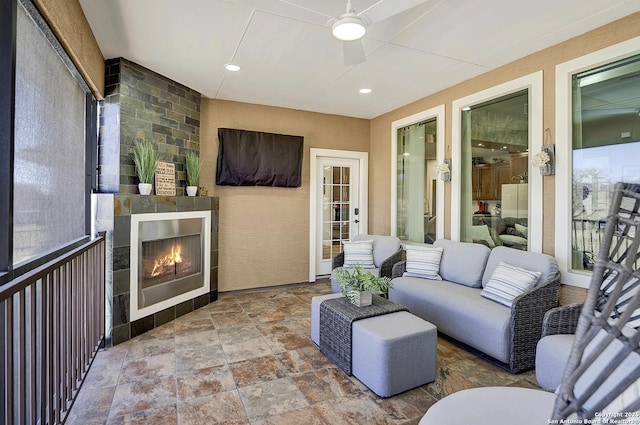 view of patio with an outdoor living space with a fireplace