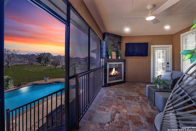 interior space featuring a fenced in pool, a patio, and ceiling fan