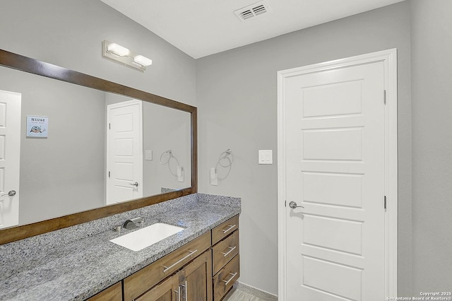 bathroom featuring visible vents and vanity