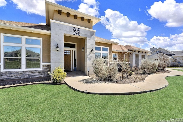 view of front of property with stone siding and a front lawn