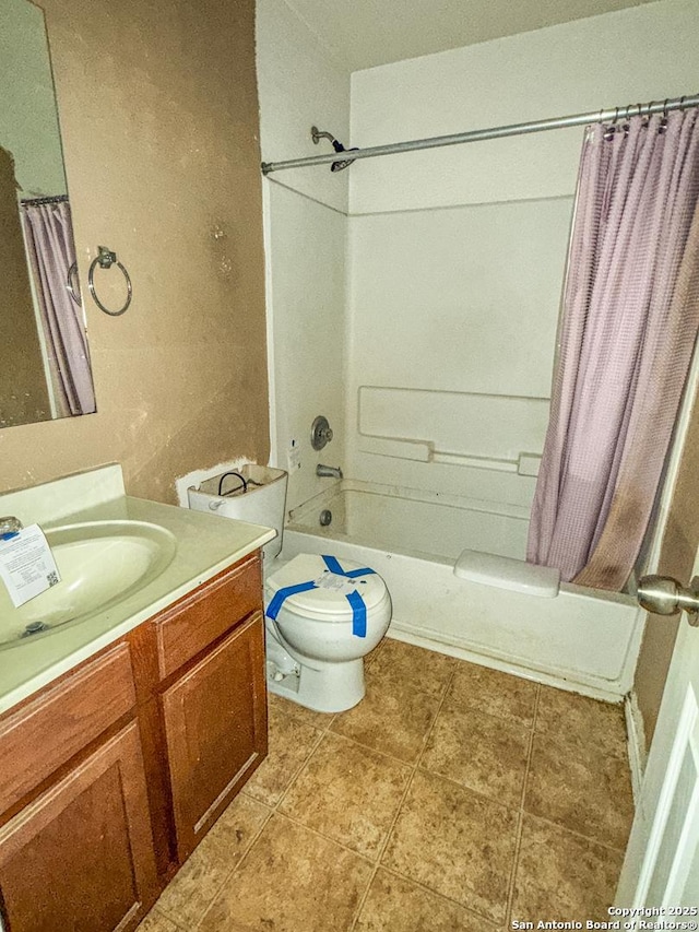 full bath with shower / tub combo, vanity, toilet, and tile patterned floors