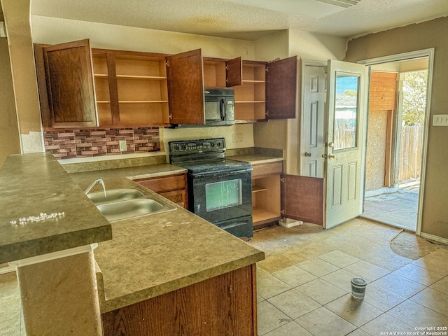 kitchen with brown cabinets, a textured ceiling, black appliances, open shelves, and a sink