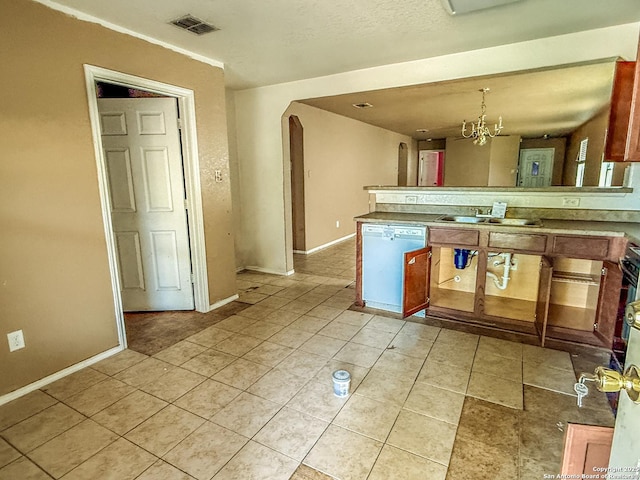 kitchen featuring visible vents, arched walkways, an inviting chandelier, white dishwasher, and a sink