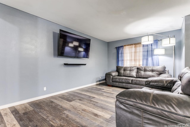 living room featuring wood finished floors and baseboards