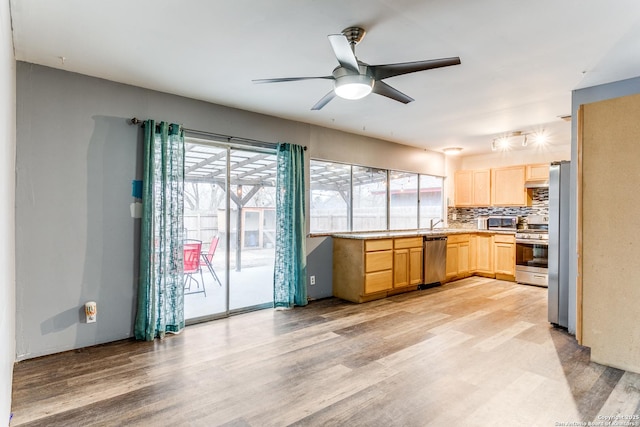 kitchen with stainless steel appliances, light wood-type flooring, and light brown cabinets