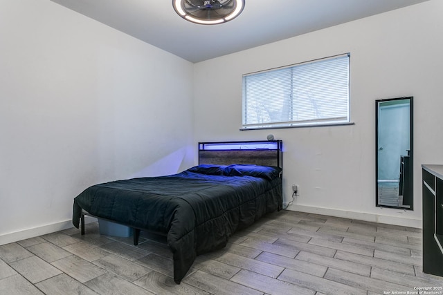 bedroom with wood tiled floor and baseboards