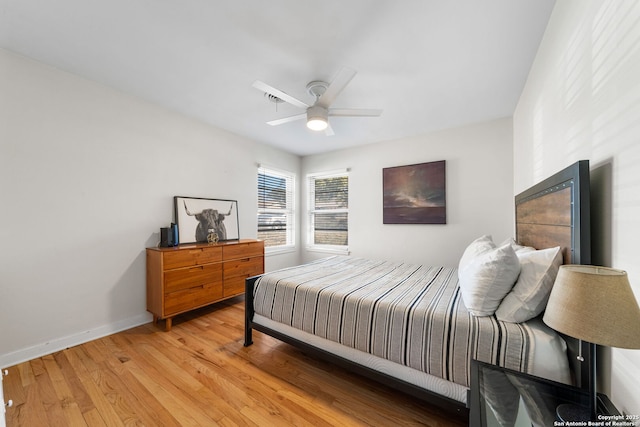 bedroom featuring light wood-style floors, ceiling fan, and baseboards