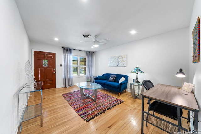 living area with hardwood / wood-style flooring, ceiling fan, visible vents, and recessed lighting