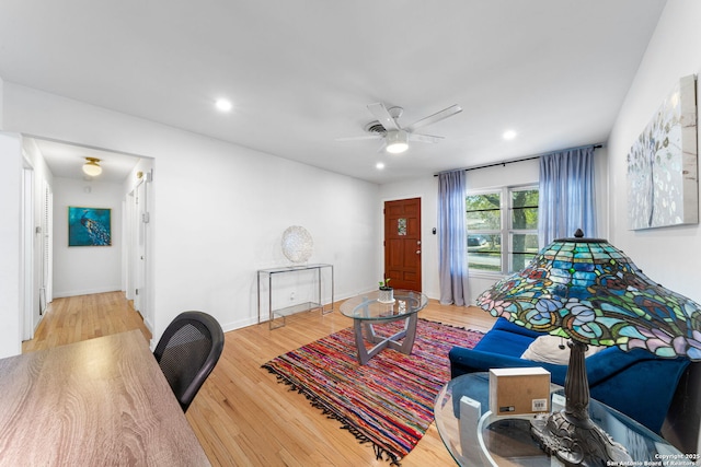 living room with baseboards, wood finished floors, a ceiling fan, and recessed lighting