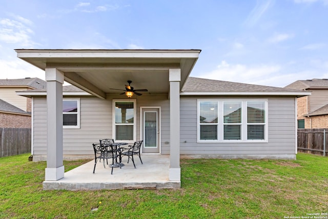 back of house featuring a patio area, a fenced backyard, a yard, and ceiling fan