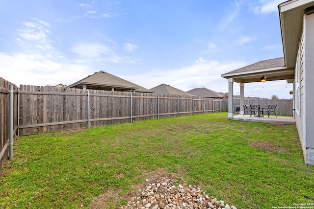 view of yard with a fenced backyard and a patio