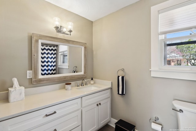bathroom featuring vanity and toilet