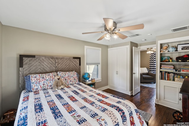 bedroom featuring visible vents, ceiling fan, baseboards, and wood finished floors