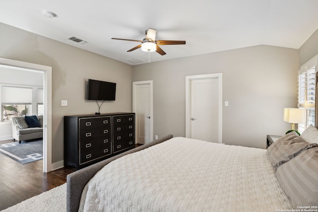 bedroom with dark wood-style flooring, visible vents, baseboards, and multiple windows
