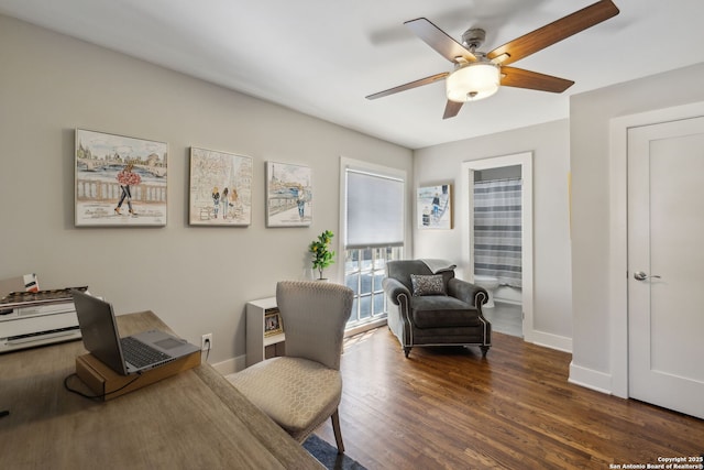 office area featuring baseboards, a ceiling fan, and wood finished floors