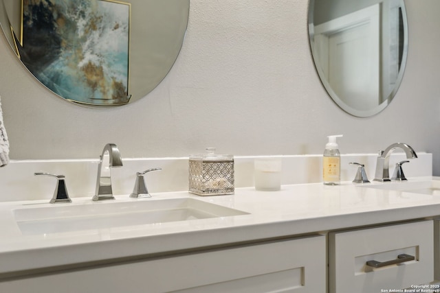 bathroom featuring a sink and double vanity