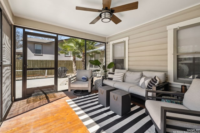 sunroom featuring an outdoor living space and a ceiling fan