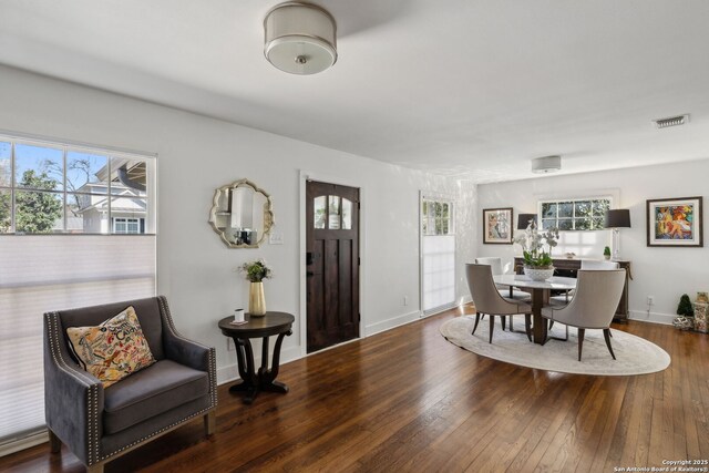 dining space featuring visible vents, hardwood / wood-style flooring, baseboards, and a healthy amount of sunlight