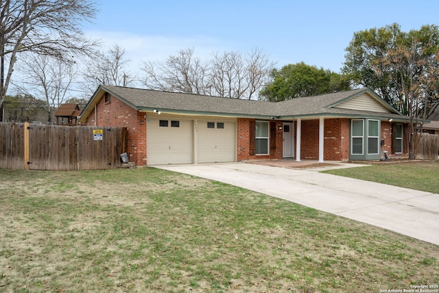 ranch-style house featuring brick siding, fence, a garage, driveway, and a front lawn