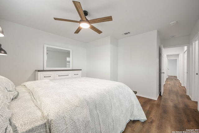 bedroom with baseboards, ceiling fan, visible vents, and dark wood-type flooring