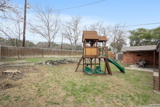 view of jungle gym with a yard, a patio area, and fence