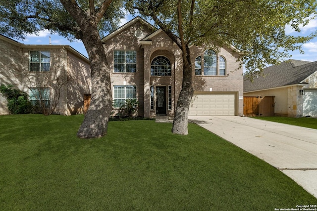 traditional-style home featuring an attached garage, driveway, brick siding, and a front yard