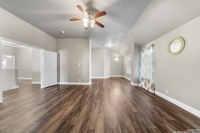 unfurnished living room with a ceiling fan, baseboards, and dark wood-style flooring